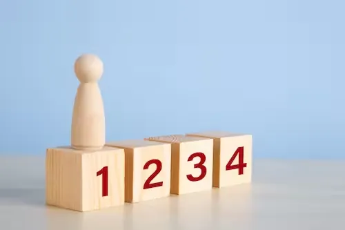 wooden figure standing on the wooden block concep 2026 03 16 03 26 31 utc